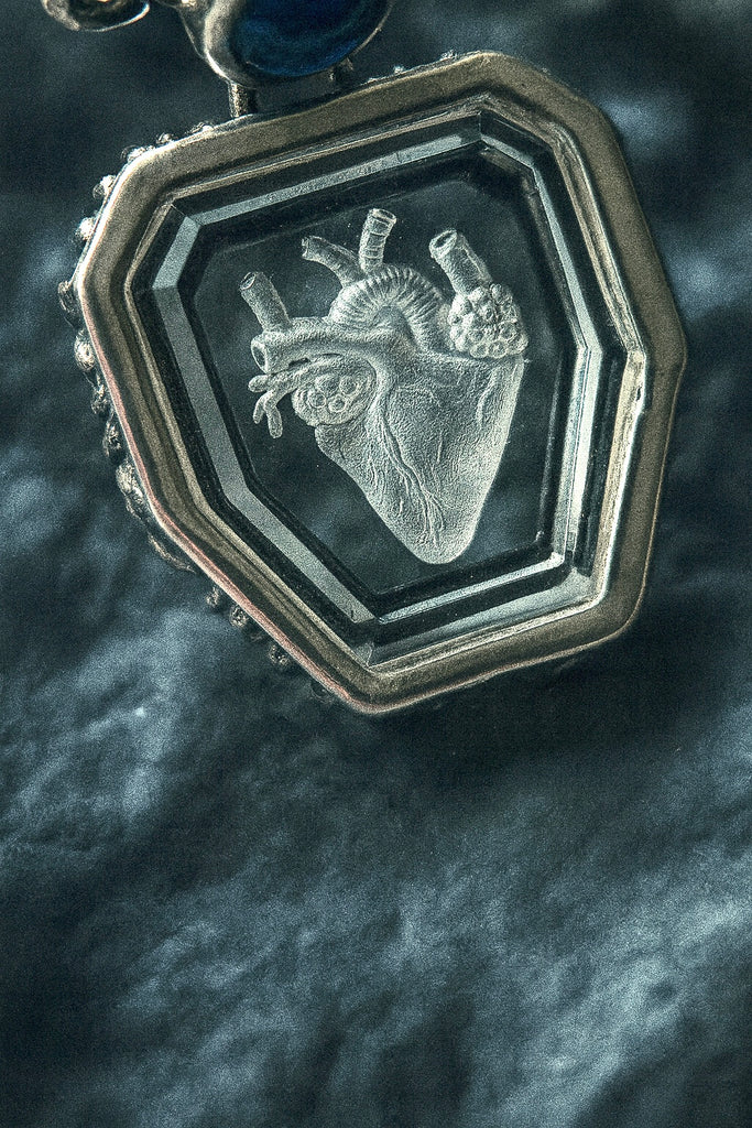 Heart engraved Crystal with blue sapphire necklace